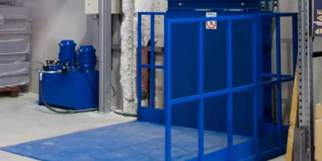 Niebieska winda magazynowa z hydraulicznym podnośnikiem ułatwia transport towarów.
